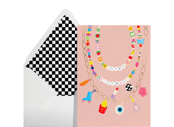 An envelope with checkered lining; a pink card with colorful beaded necklaces that read 'happy birthday.'